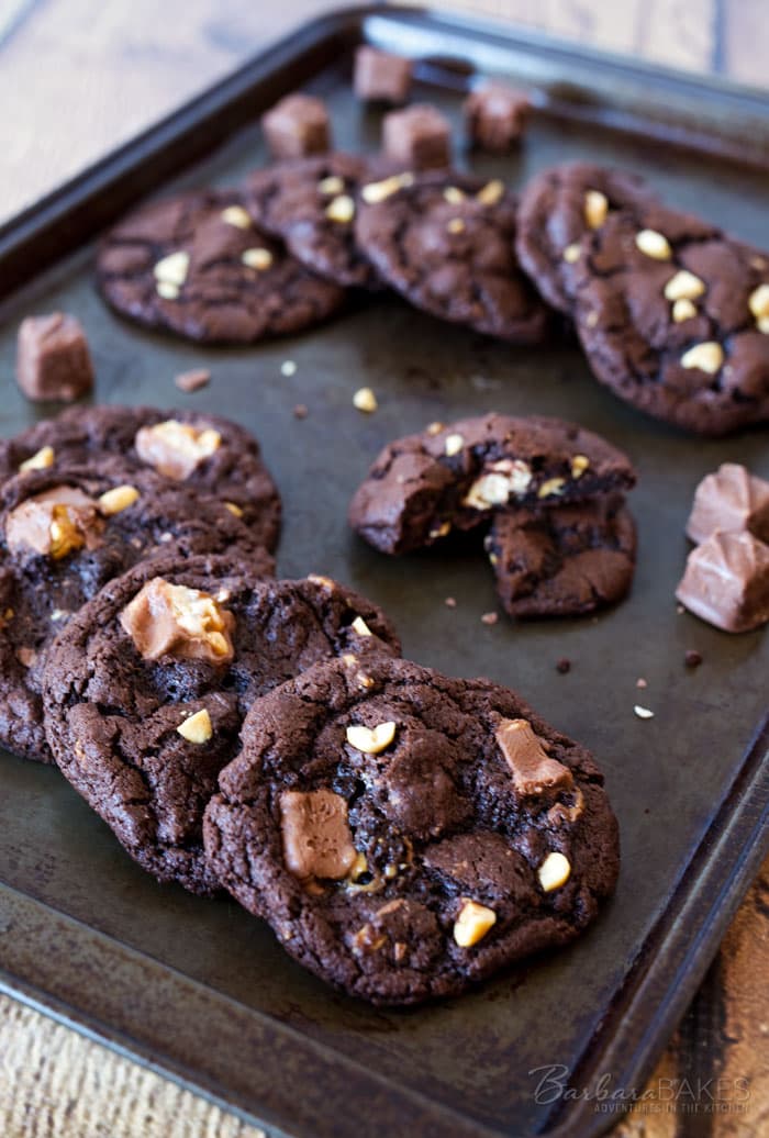 These Chocolate Snickers Cookies are an irresistible, rich, chewy chocolate cookie loaded with chocolate chips, peanuts and Snickers Baking Bites. 
