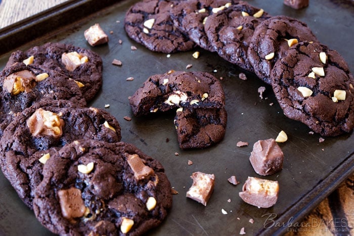 These Chocolate Snickers Cookies are an irresistible, rich, chewy chocolate cookie loaded with chocolate chips, peanuts and Snickers Baking Bites. 