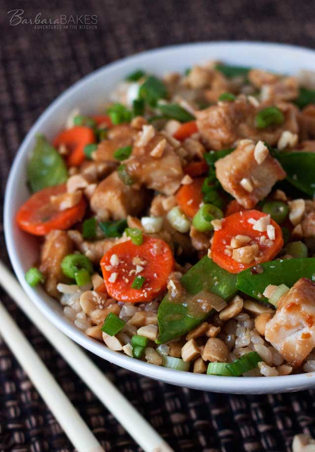 A quick and easy Kung Pao chicken loaded with fresh veggies in a spicy sauce sprinkled with green onions and chopped peanuts.