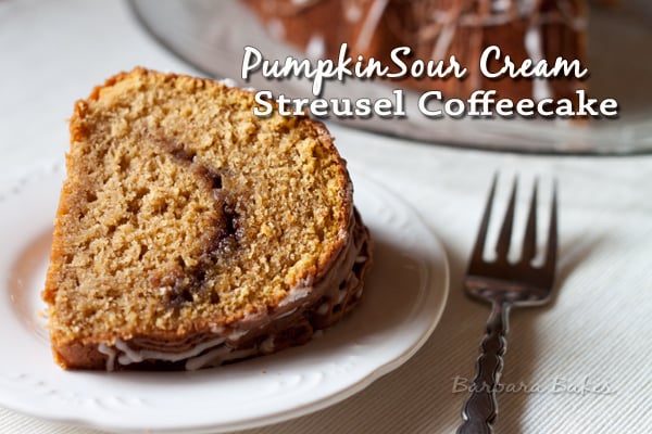 a slice of Pumpkin Sour Cream Coffee Cake on a white plate with a fork