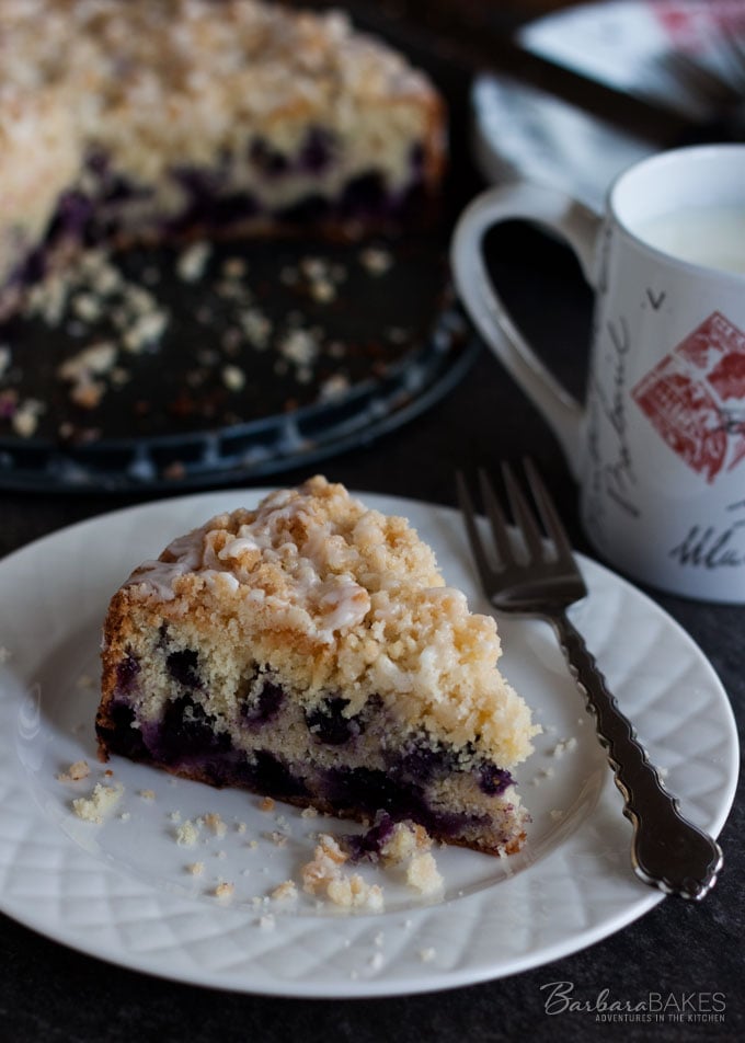 Lemon Blueberry Coffee Cake - Tender, moist lemon coffee cake loaded with blueberries crowned with a crunchy, sweet crumb topping and drizzled with a tart lemon glaze. 