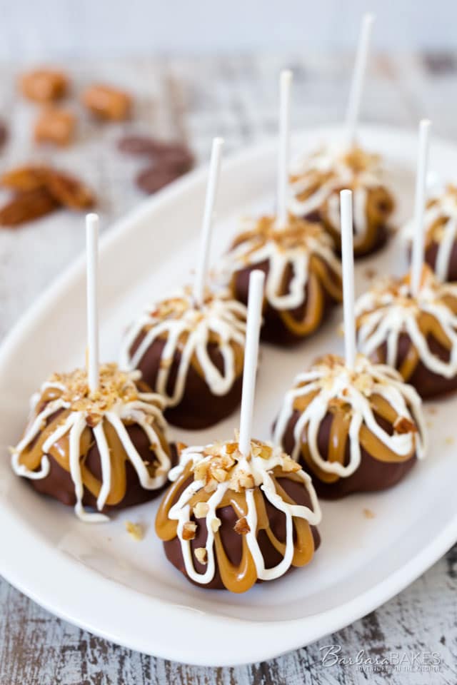 Chocolate Covered Cheesecake Pops on a white platter