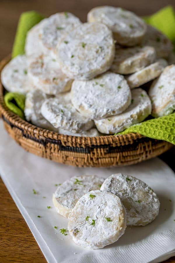 Lime Meltaway Cookies covered in powdered sugar. 
