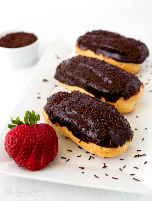 Chocolate Eclairs are made by filling a crisp, buttery eclair shell with a light, creamy vanilla pastry cream and glazing it with a rich, chocolate icing.