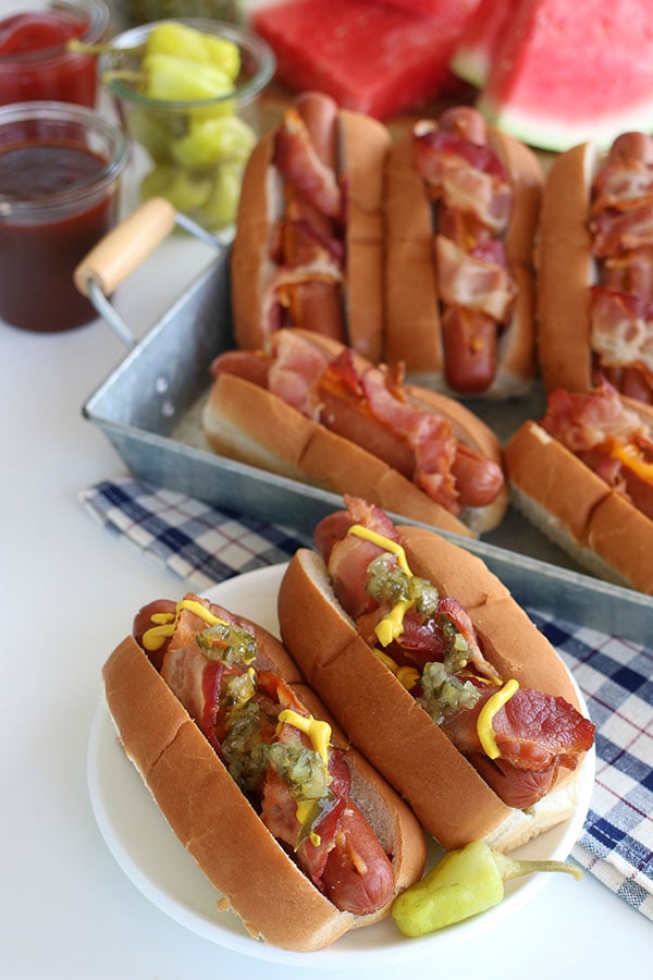 Bacon Wrapped Cheese Hot Dogs in a bun with relish