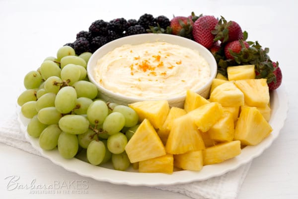 Creamy-Orange-Fruit-Dipwith a plate of fruit including grapes, pineapple, strawberries and blackberries