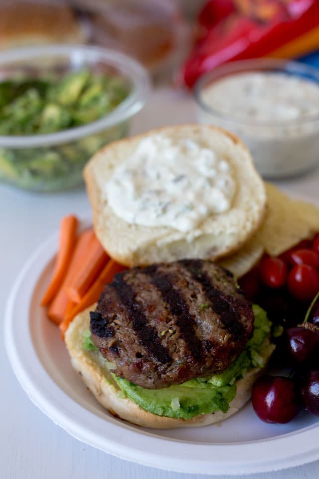 Burgers made with bacon and roasted peppers, dripping with a queso cheese sauce and loaded with an avocado salsa. A great way to kick it up a notch.