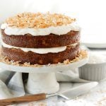 Two layer Tropical Carrot Cake with Coconut Cream Cheese frosting on a cake stand