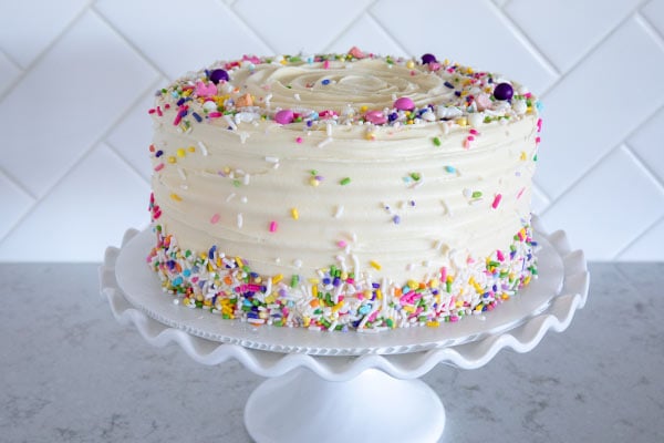 Triple Layer Chocolate Cheesecake with Cream Cheese Frosting and colorful sprinkles