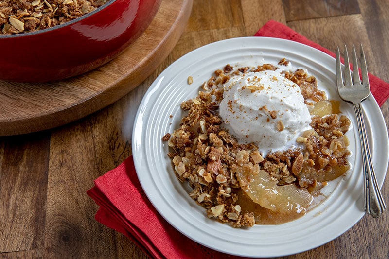 Apple Crisp on a Plate with a Scoop of Vanilla Ice Cream