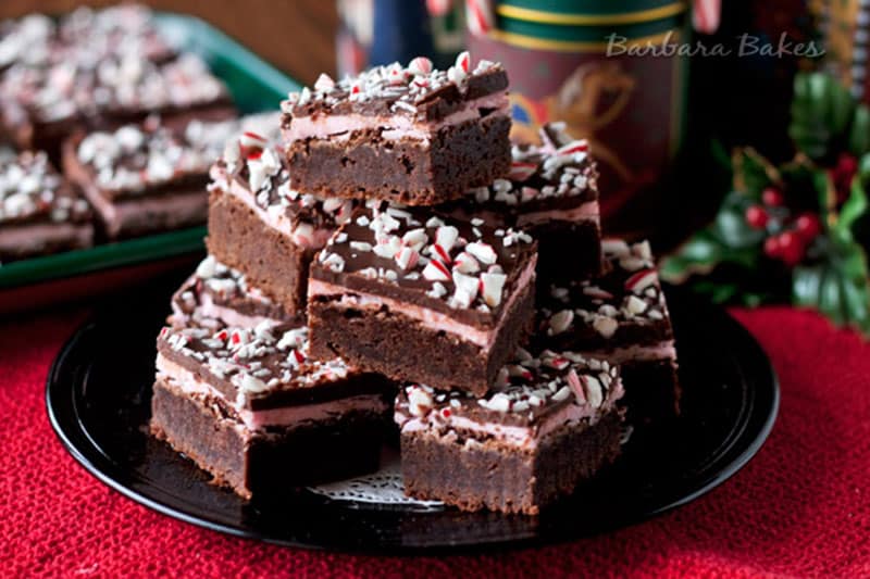 peppermint candy cane brownies stacked on a serving platter