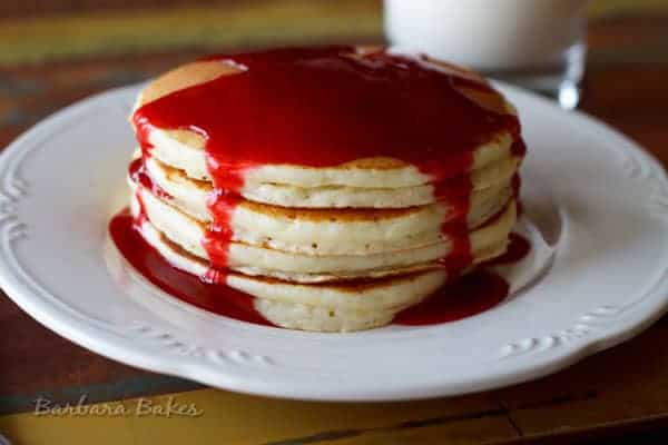 Lemon ricotta pancakes drizzled with raspberry syrup. The ricotta adds a rich, fluffy texture and beaten egg whites makes them light as air.