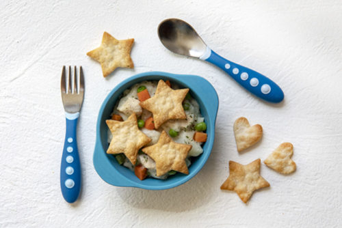 Deconstructed Chicken Pot Pie in a child's blue bowl with children's fork and spook