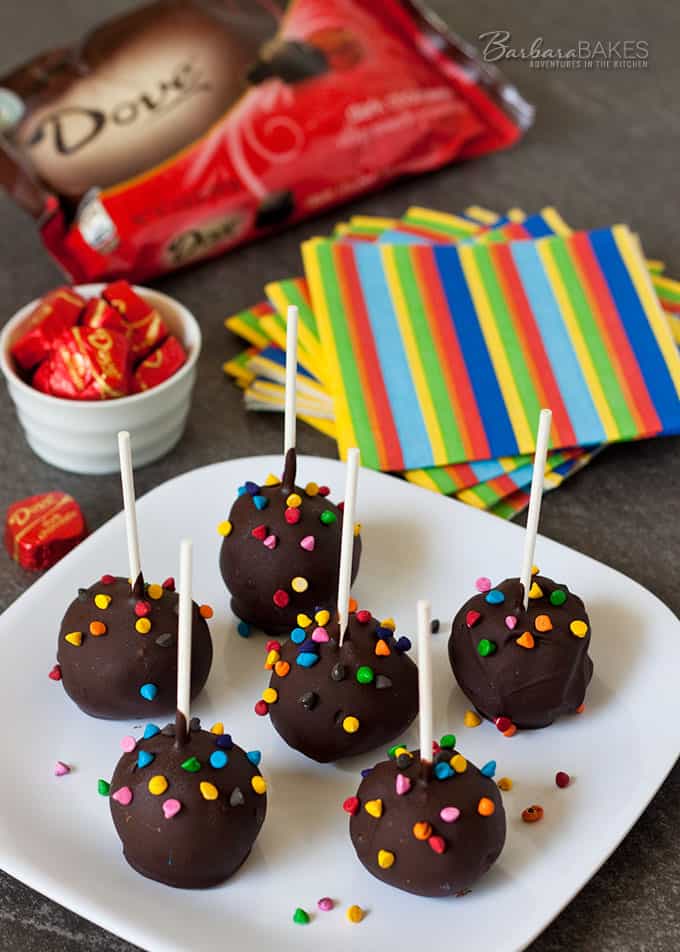 homemade chocolate covered cake pops sitting on a white dessert plate