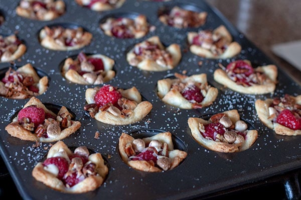 Rugelach in mini tin filled with raspberries, white chocolate and nuts.