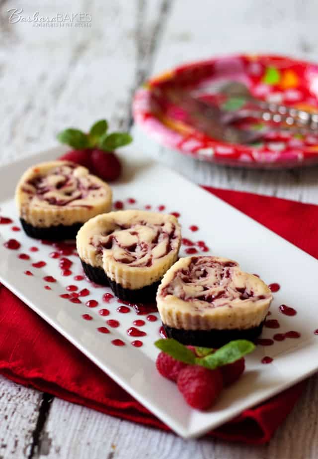 Heart-Shaped Mini Raspberry Swirl Cheesecake on a white platter
