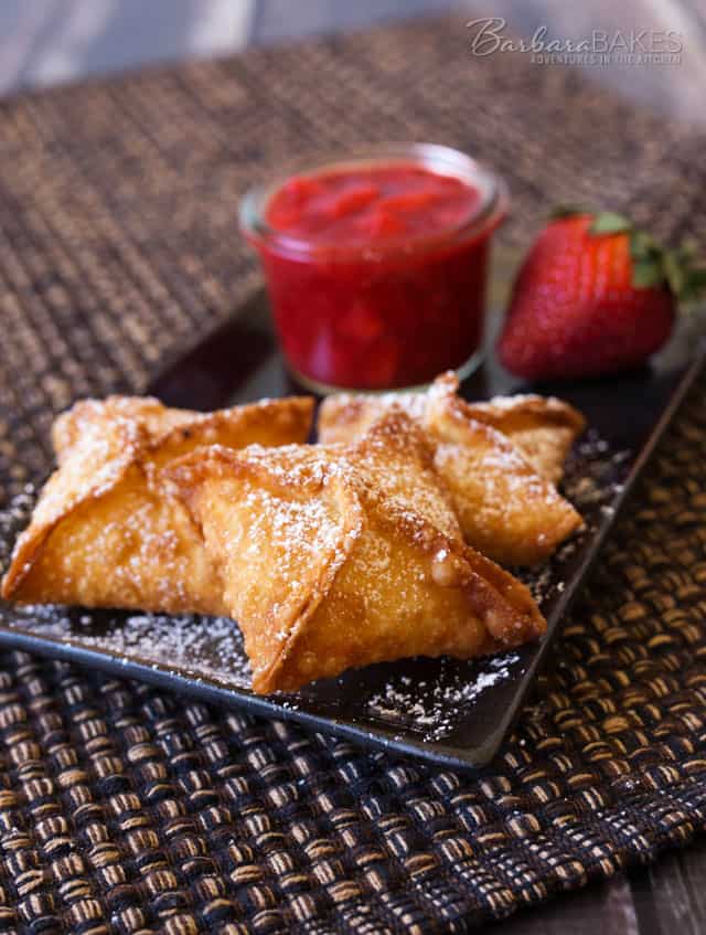 Strawberry Cheesecake Wontons with a cheesecake filling deep fried until they’re golden brown and crispy, then served with a sweet, fresh strawberry sauce.