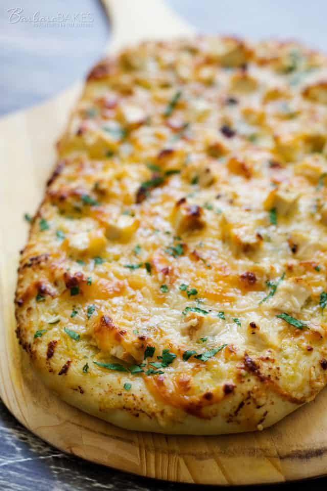 An easy-to-make flatbread topped with a flavorful lemon artichoke pesto, diced grilled chicken and smokey gouda cheese then baked until it's golden brown and gooey, cheesy delicious. 