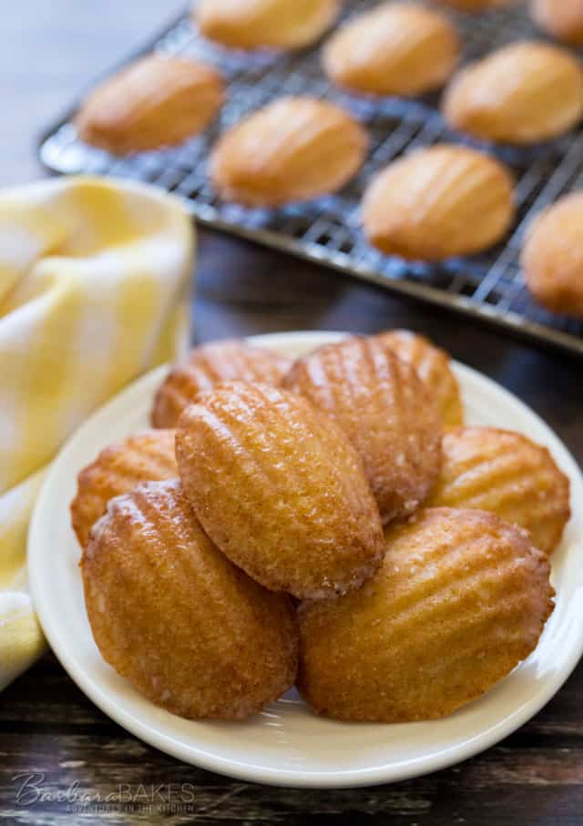 Tender little scalloped shaped lemon cakes coated with a tart lemon glaze. A beautiful French dessert that's actually easy to make. 