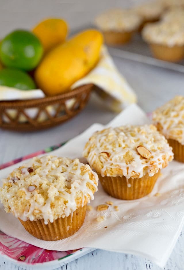 Tender, light, fluffy muffin Mango Lime Muffins loaded with chunks of mango, topped with a sweet, almond streusel, and drizzled with a tart lime glaze.