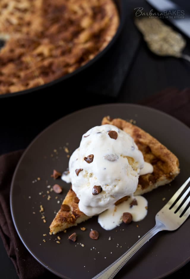 This Snickerdoodle Skookie is a big snickerdoodle cookie studded with cinnamon chips baked in a cast iron skillet served warm with a scoop of vanilla ice cream. 