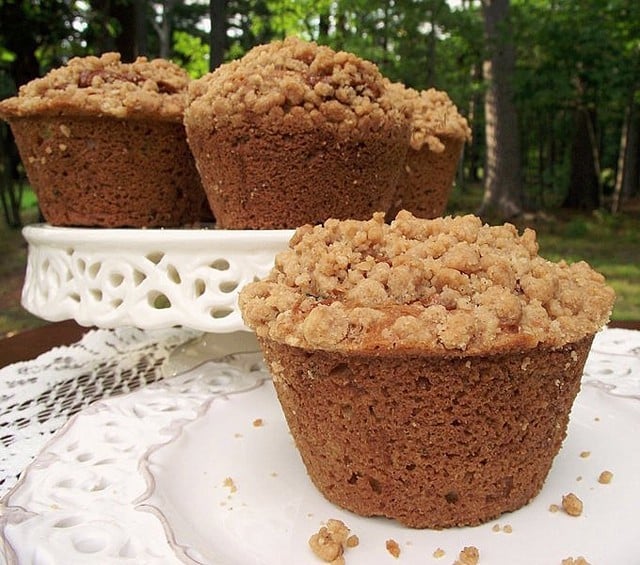 Crumb Topped Caramel Zucchini Muffins with a swirl of Dulce de Leche hiding inside and a buttery, crunchy crumb topping.