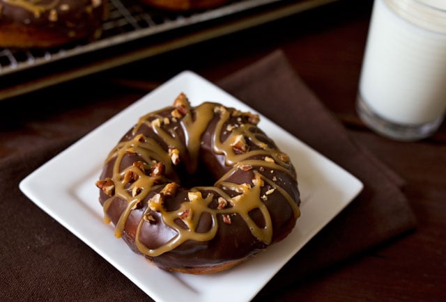 Brioche donuts dipped in a rich chocolate ganache sprinkled with toasted chopped pecans then drizzled with a sweet, gooey caramel. The flavors of a turtle chocolate candy in an irresistible donut.