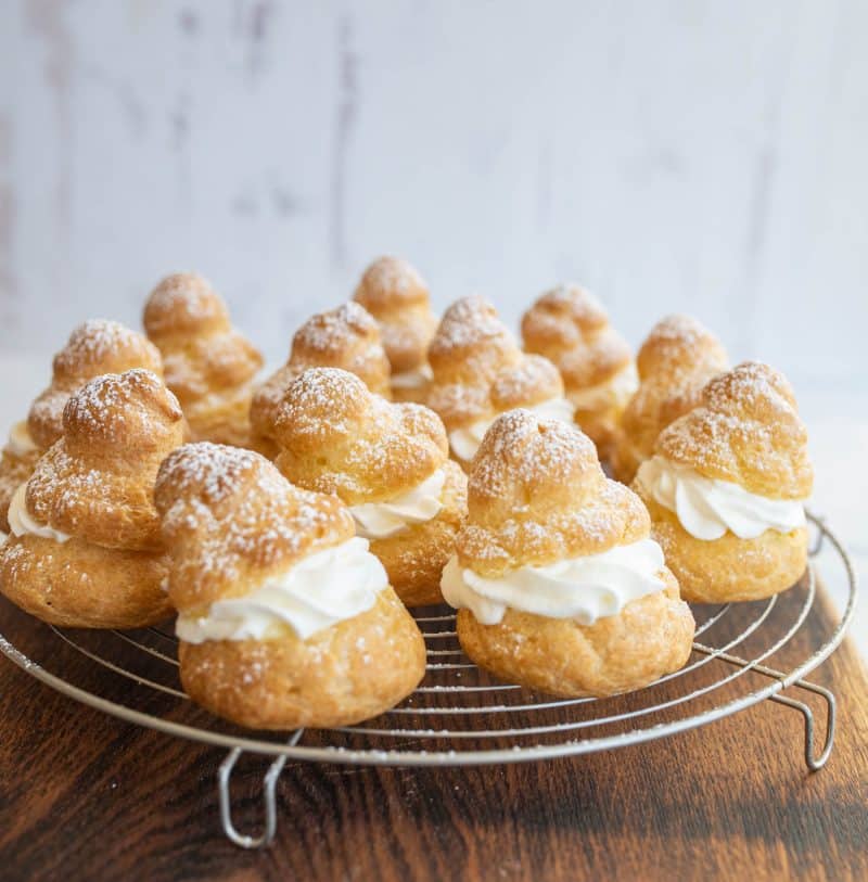 12 cream puffs on cooling rack