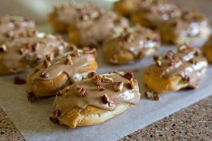 Maple Pecan eclairs filled with a rich, creamy maple custard, iced with a maple icing, and decorated with chopped pecans. If you love a maple bar donut, you're going to go crazy for this eclair.