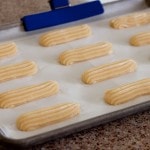 Eclair dough piped on a baking sheet using the templates from my new cookbook Simply Sweet Dream Puffs.