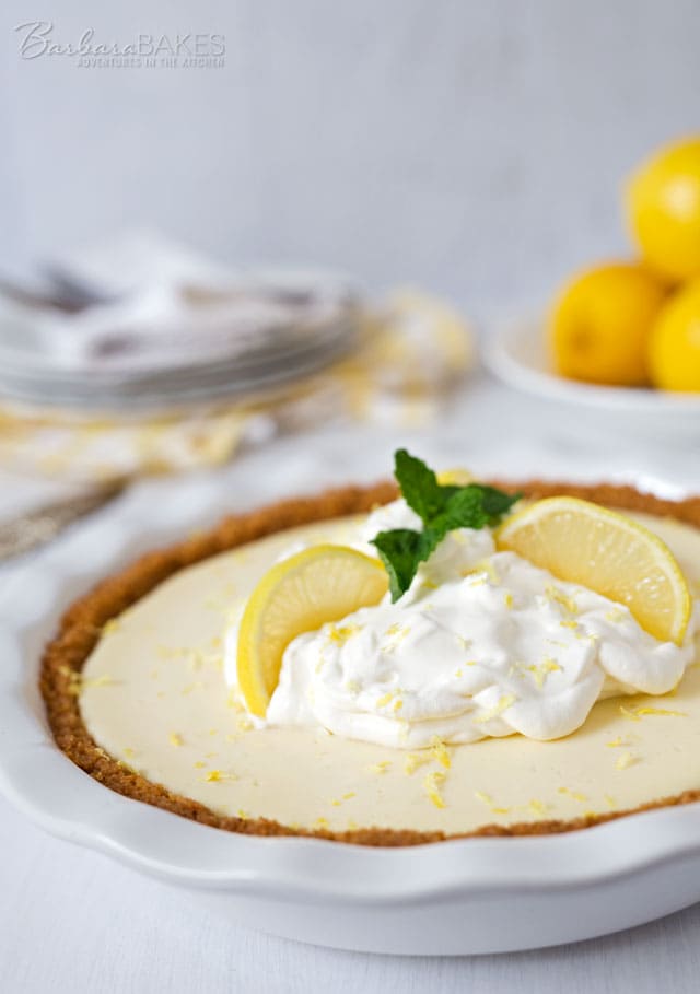 A Creamy Lemon Yogurt Pie in a crisp graham cracker crust. The easy-to-make lemon filling gets it's creamy texture and a little extra tang from the addition of Greek yogurt.