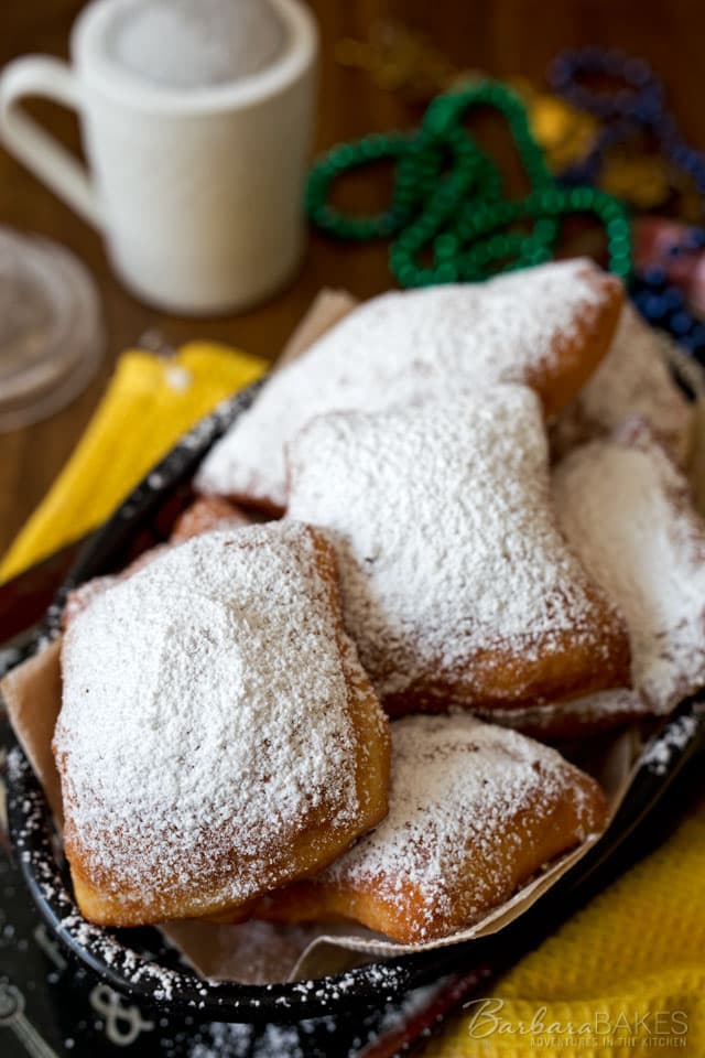 Light and airy easy beignets served piping hot dusted with a thick layer of powdered sugar. An irresistible French doughnut that is a New Orleans speciality. 