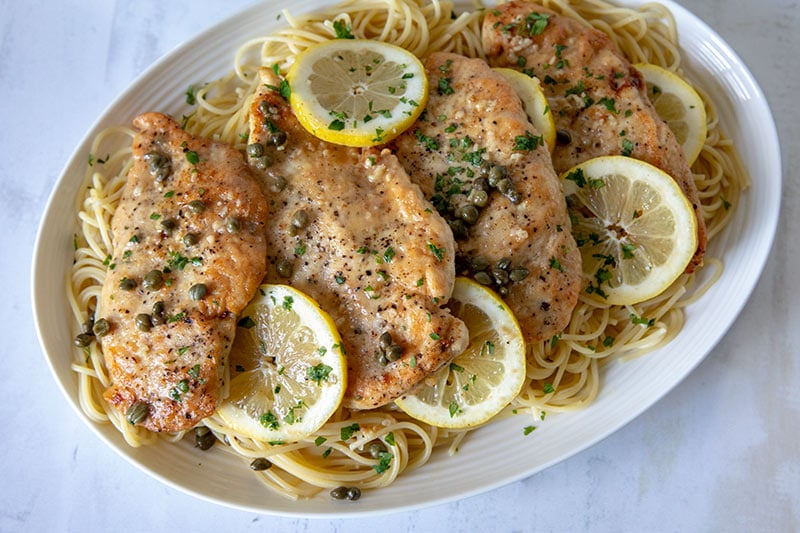 Chicken-Piccata-With-Pasta on a white platter