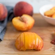 Peaches in various stages of slicing