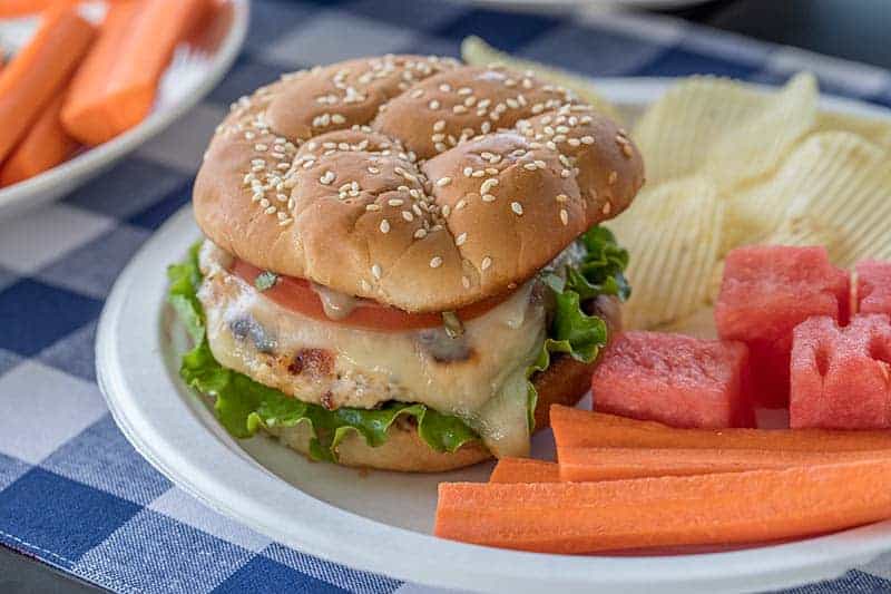 A grilled chicken burger topped with melty mozzarella, tomato, basil and a flavorful balsamic mayo. It's a must try burger this summer.