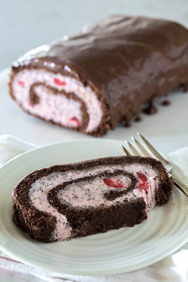 This Cherry Chocolate Chip Ice Cream Cake Roll starts with a thin, rich chocolate sponge cake spread with cherry chocolate chip ice cream rolled up and frozen, then before serving it’s covered in a luscious chocolate ganache.
