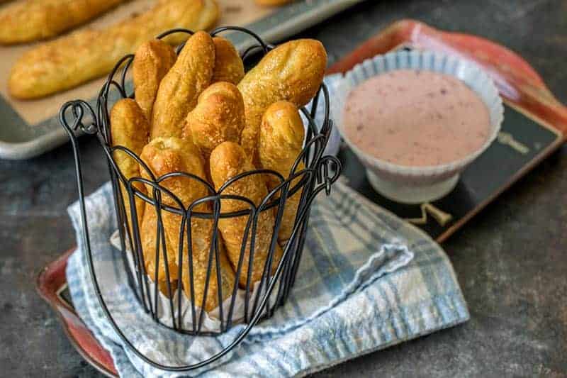 Sweet Pretzels Sticks in a wire basket with Strawberry Cream Cheese Dip