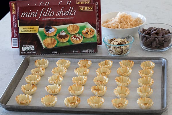 mini fillo shells on a baking sheet, ready to be filled with coconut pie filling