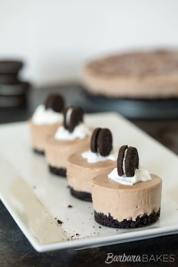 Four individual servings of Frozen Chocolate Oreo Pie with large pie in the background