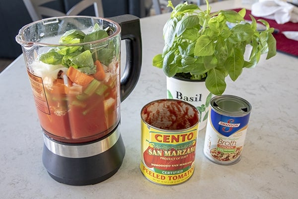 ingredients for Ace Blender Tomato Basil Soup being added to the blender