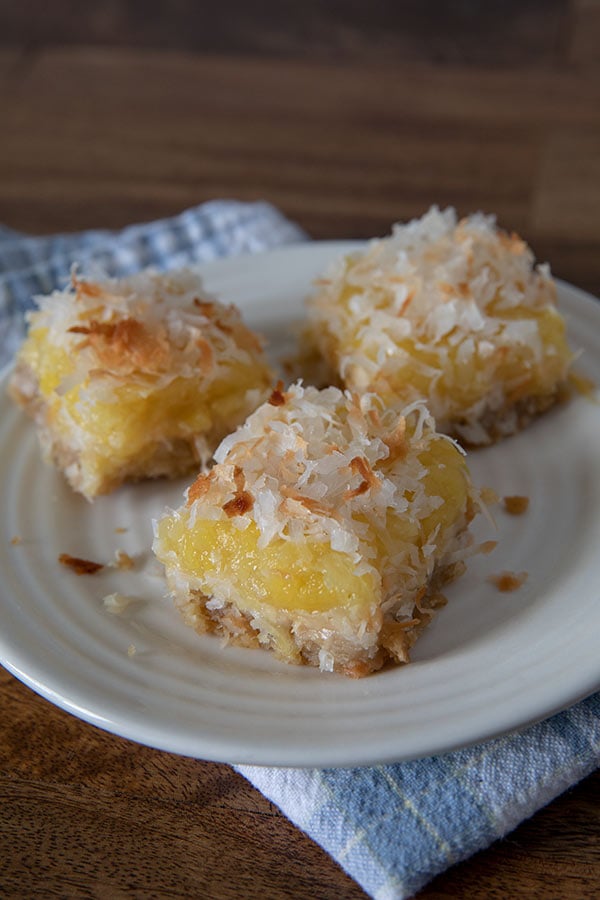 Pineapple Coconut Bars sliced and served on a white plate