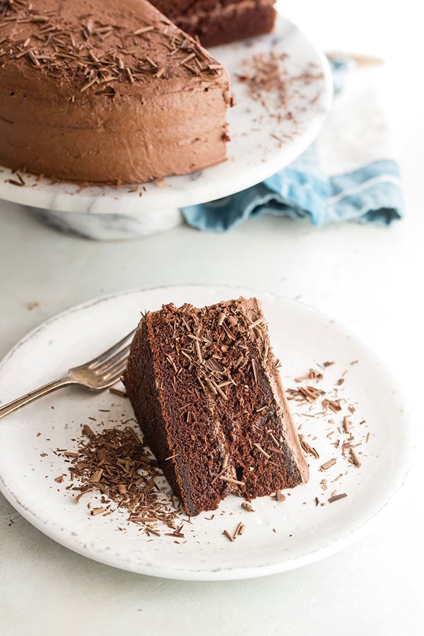 A slice of The Hershey's Perfectly Chocolate Chocolate Cake with chocolate shavings.