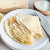 Three Crepes With Lemon Ricotta Filling on a plate