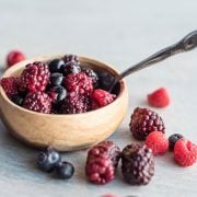 Triple Berry Compote with Fresh Berries in a wooden bowl with a spoon in it