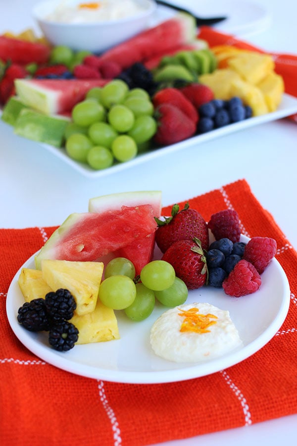 Creamy Orange Fruit Dip on a plate with a variety of fruit