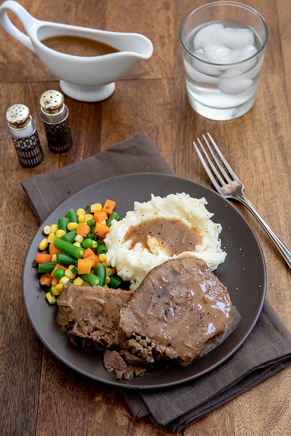 Round Steak and Gravy with Mashed Potatoes and Mixed Vegetables and extra gravy for serving