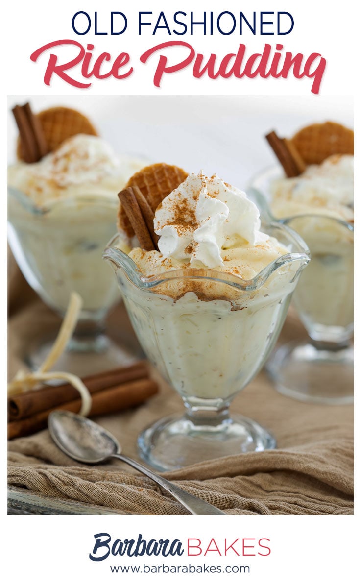 Close up on three glass goblets of homemade old-fashioned white rice pudding flavored with cinnamon and topped with whipped cream and waffle cookies.
