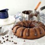 A chocolate bundt cake with drizzle of chocolate frosting