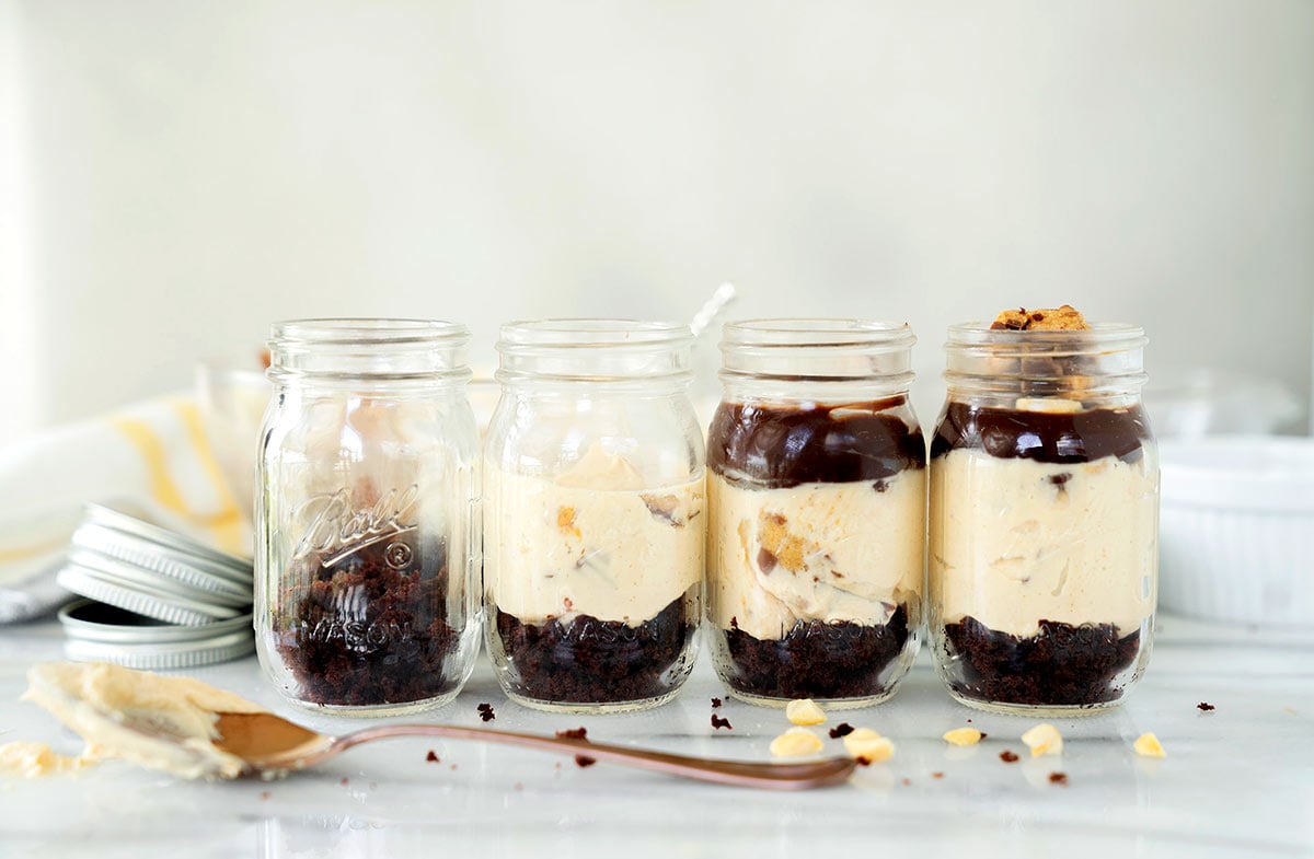 4 mason jars - one filled with just cake crumbles, then adds a layer of peanut butter cheesecake, the next jar adds chocolate ganache and the final jar adds chopped peanut butter cups and peanuts.