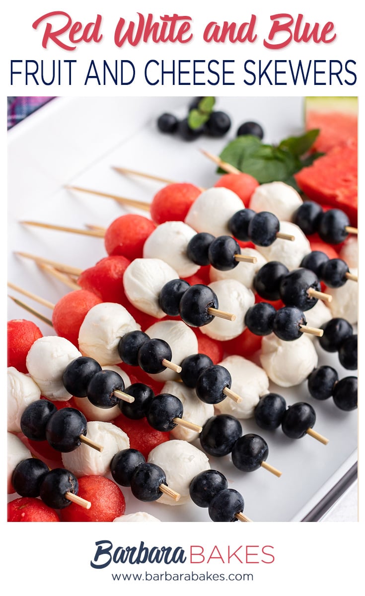 Close up of Red, White and Blue Fruit and Cheese skewers on a white platter
